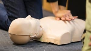 Students practicing CPR during certification class comparing HSI AHA and Red Cross programs