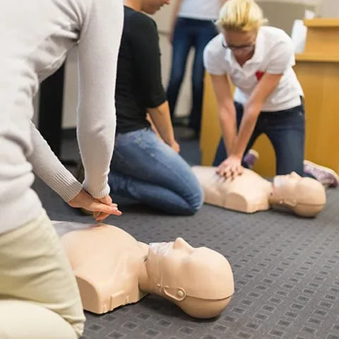 Adult CPR training in Houston with students practicing chest compressions