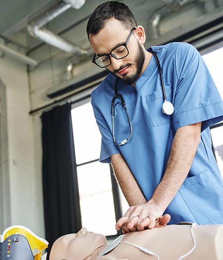 BLS Certification Student performing compressions during AHA BLS certification class in Houston