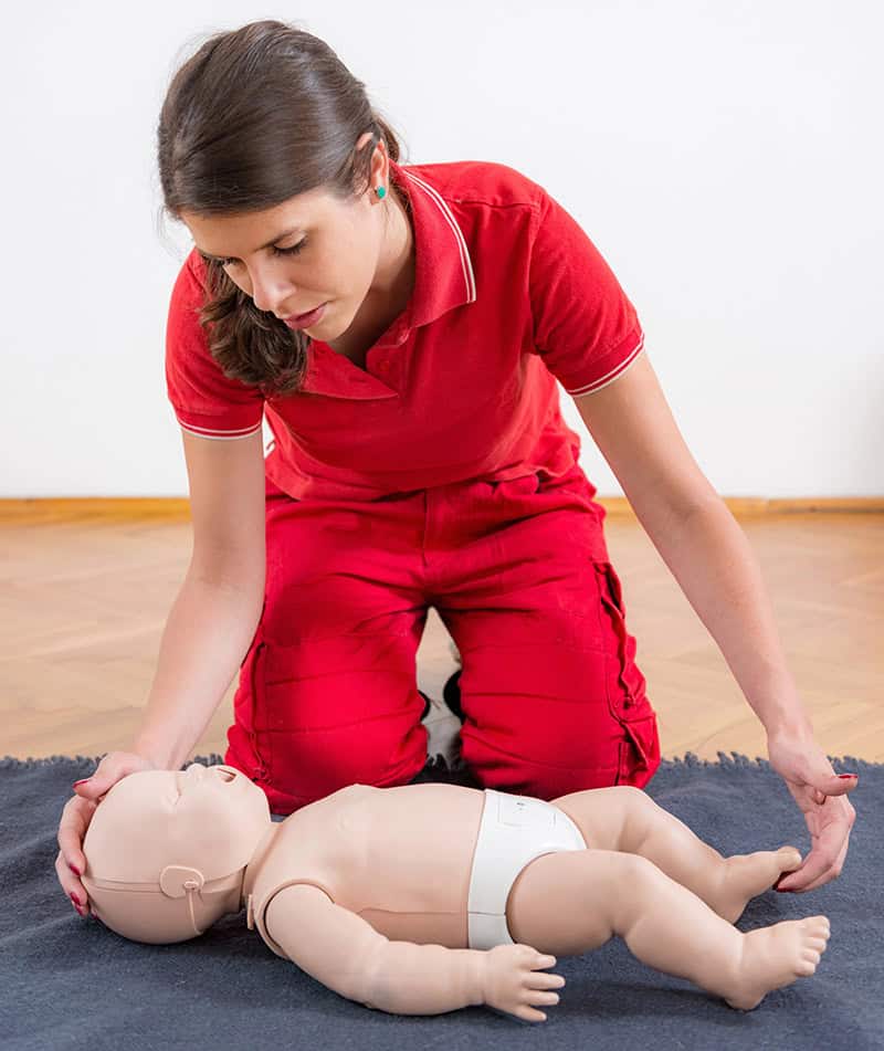 Daycare staff learning pediatric AED use during CPR training